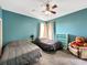 Teal bedroom with two beds and ceiling fan at 7045 Greengrove Blvd, Clermont, FL 34714