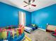 Blue bedroom with a ceiling fan and ample space at 7045 Greengrove Blvd, Clermont, FL 34714