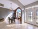 Bright dining room with an arched window and chandelier at 7045 Greengrove Blvd, Clermont, FL 34714