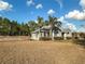 Ranch-style home with palm trees and a fenced yard at 7045 Greengrove Blvd, Clermont, FL 34714