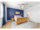 Spacious bedroom with a blue accent wall and a king-size bed at 7865 Sw 89Th Cir, Ocala, FL 34481