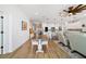 Open concept dining area with wooden table and chairs, hardwood floors, and a view of the living room and kitchen at 7865 Sw 89Th Cir, Ocala, FL 34481