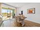 Casual dining area with wooden table and chairs near sliding doors leading to a patio at 7865 Sw 89Th Cir, Ocala, FL 34481