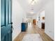 Bright entryway with blue console table and hardwood floors at 7865 Sw 89Th Cir, Ocala, FL 34481