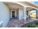 Covered front porch with stone columns and paver floor at 7865 Sw 89Th Cir, Ocala, FL 34481