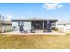 Rear view of house showcasing patio, lanai, and fenced yard at 7865 Sw 89Th Cir, Ocala, FL 34481