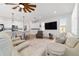 Spacious living room with light-colored furniture, a ceiling fan, and an open floor plan at 7865 Sw 89Th Cir, Ocala, FL 34481