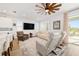 Relaxing living room featuring a neutral color palette, comfortable seating, and a large TV at 7865 Sw 89Th Cir, Ocala, FL 34481