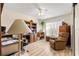 Bedroom with laminate wood flooring, ceiling fan, and built-in shelving at 8594 Sw 61St Ct, Ocala, FL 34476