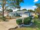 House with a two-car garage and front yard landscaping at 8594 Sw 61St Ct, Ocala, FL 34476