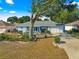 Single-story home with landscaped yard, driveway, and mature tree at 8594 Sw 61St Ct, Ocala, FL 34476