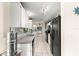 Clean kitchen featuring white cabinets and black appliances at 8594 Sw 61St Ct, Ocala, FL 34476