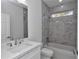 Clean bathroom with white vanity, marble tile shower, and bathtub at 8786 Sw 127 Ave, Dunnellon, FL 34432