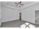 Sunlit bedroom featuring wood-look floors and ceiling fan at 8786 Sw 127 Ave, Dunnellon, FL 34432