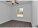 Bright bedroom featuring wood-look floors and a large window at 8786 Sw 127 Ave, Dunnellon, FL 34432