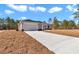 Single story home exterior with a two car garage and concrete driveway at 8786 Sw 127 Ave, Dunnellon, FL 34432