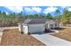 New construction home exterior with light beige siding and gray roof at 8786 Sw 127 Ave, Dunnellon, FL 34432