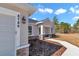 House exterior showcasing a walkway to the front door and landscaping at 8786 Sw 127 Ave, Dunnellon, FL 34432