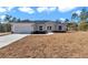 Newly built home with a two-car garage and well-manicured lawn at 8786 Sw 127 Ave, Dunnellon, FL 34432