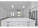 Kitchen island with white cabinets and stainless steel appliances at 8786 Sw 127 Ave, Dunnellon, FL 34432