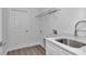 Bright laundry room with utility sink and storage at 8786 Sw 127 Ave, Dunnellon, FL 34432