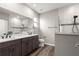 Modern bathroom featuring a double vanity, wood-look flooring, and tiled walk-in shower at 8902 Sw 75Th Loop, Ocala, FL 34481