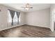 Bright bedroom featuring wood floors and a large window with sheer curtains at 8902 Sw 75Th Loop, Ocala, FL 34481