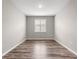 Bedroom featuring wood-look floors, neutral paint, and a window with blinds at 8902 Sw 75Th Loop, Ocala, FL 34481