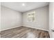 Bedroom featuring wood-look floors, neutral paint, a window, and a ceiling light at 8902 Sw 75Th Loop, Ocala, FL 34481