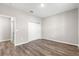 Bedroom with wood-look flooring, neutral paint, and a closet with double doors at 8902 Sw 75Th Loop, Ocala, FL 34481