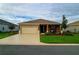 A cozy single-story home with a well-manicured front yard and a two-car garage at 8902 Sw 75Th Loop, Ocala, FL 34481