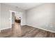 Open-concept living room with wood-look floors, neutral paint, and entry to the kitchen at 8902 Sw 75Th Loop, Ocala, FL 34481