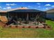 Inviting screened-in patio with outdoor furniture, complemented by landscaping and green lawn at 8902 Sw 75Th Loop, Ocala, FL 34481