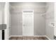 Walk-in closet featuring white wire shelving, neutral paint, and wood-look flooring at 8902 Sw 75Th Loop, Ocala, FL 34481