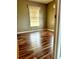 This bedroom features laminate floors, a window with blinds, and neutral-colored walls at 8986 Se 120Th Pl, Belleview, FL 34420