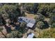 An aerial view of home with a fenced yard, outbuildings, and mature trees at 9352 Ne 27Th Ter, Anthony, FL 32617