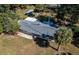 Birds-eye view of the home with a metal roof and mature trees and landscaping at 9352 Ne 27Th Ter, Anthony, FL 32617