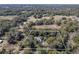 Aerial shot outlining a home, nestled in a picturesque, tree-filled landscape at 9352 Ne 27Th Ter, Anthony, FL 32617