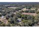 Serene aerial view of a property surrounded by lush trees and a sprawling landscape at 9352 Ne 27Th Ter, Anthony, FL 32617