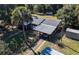 Overhead shot of a home with a car port, screened patio, and mature landscaping at 9352 Ne 27Th Ter, Anthony, FL 32617