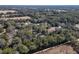 Expansive aerial view showing the property's location amid lush trees, offering a tranquil and secluded setting at 9352 Ne 27Th Ter, Anthony, FL 32617