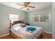 Bright bedroom with two windows, a ceiling fan, and hardwood floors at 9352 Ne 27Th Ter, Anthony, FL 32617