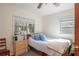 Sunlit bedroom with hardwood floors, a ceiling fan, and natural light from two windows at 9352 Ne 27Th Ter, Anthony, FL 32617