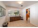 Light-filled dining area featuring tiled floors, wood paneled walls, and a wooden credenza beneath the window at 9352 Ne 27Th Ter, Anthony, FL 32617