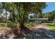 View of home with covered parking, a screened-in porch and mature landscaping at 9352 Ne 27Th Ter, Anthony, FL 32617