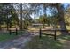 Gated property with a long driveway, lush trees and foliage provides privacy at 9352 Ne 27Th Ter, Anthony, FL 32617