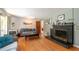 Cozy living room featuring hardwood floors, and a black brick fireplace at 9352 Ne 27Th Ter, Anthony, FL 32617