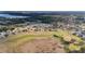 An aerial view of a golf course community featuring well-maintained homes and lush landscaping in a desirable neighborhood at 9651 Se 137Th Street Rd, Summerfield, FL 34491