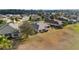 Aerial view of the back of the home featuring the screened lanai and landscaping at 9651 Se 137Th Street Rd, Summerfield, FL 34491