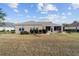 Spacious backyard featuring a screened lanai, perfect for outdoor relaxation at 9651 Se 137Th Street Rd, Summerfield, FL 34491